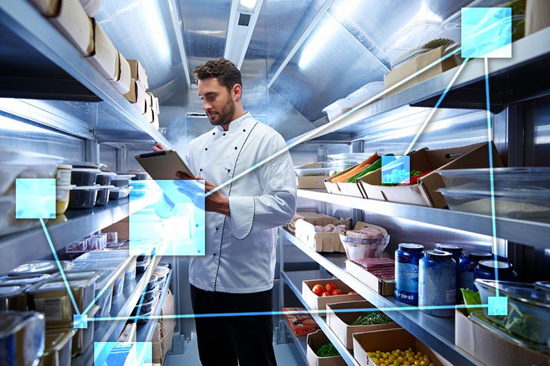 Chef doing inventory control with TVI - features automatic ingredient reordering and smart food cost management. 