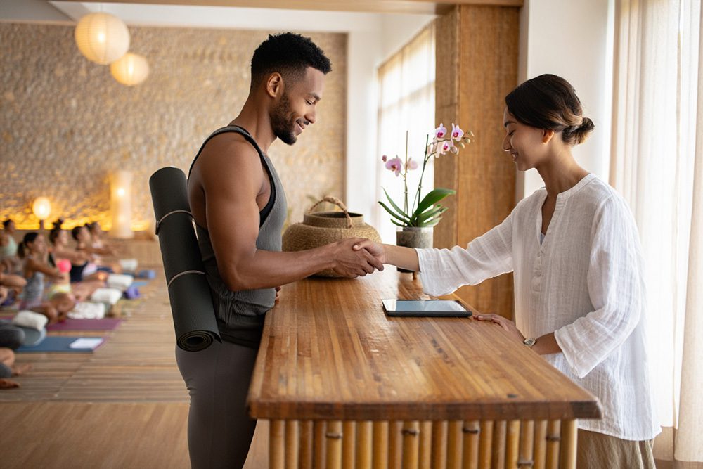Yoga student checking in at yoga class.