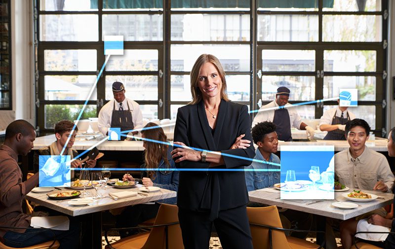 Proud restaurant owner overseeing service - TVI integrated business management software.